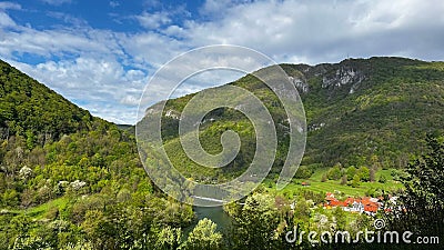 Scenic valley of river Kolpa encircled with green vegetation and mountains in Solveina Stock Photo
