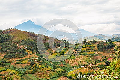 Scenic view of African landscape with houses and farms against a Mountain background in rural Uganda Stock Photo