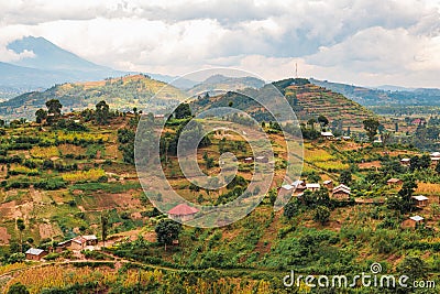 Scenic view of African landscape with houses and farms against a Mountain background in rural Uganda Stock Photo