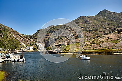 Scenic view of boats moored at the bank of Ezaro river in Spain Stock Photo