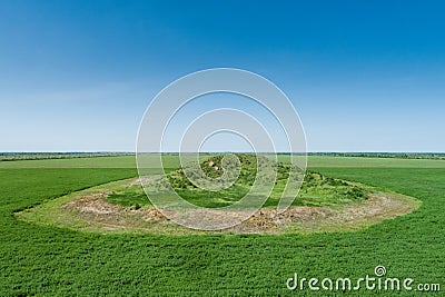 Scenic view of the burial mound of the Scythian king in a green field. Aerial view Stock Photo