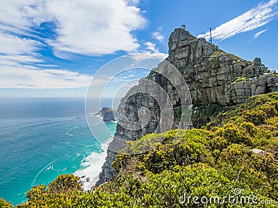 Scenic view on Cape Point with lighthouse, ocean and dramatic sky, Cape Town, South Africa Stock Photo