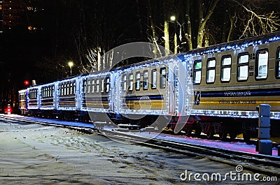 Scenic view of Christmas decorated train by lights. Train arrived at the station Editorial Stock Photo