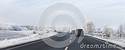 Scenic view clean intercity highway road drive cars with beautiful white covered snow trees blue sky on background at Editorial Stock Photo