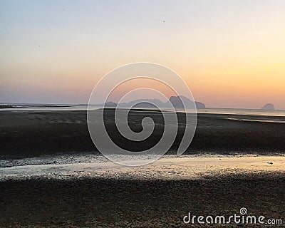 Scenic view of coast against sunset sky Stock Photo