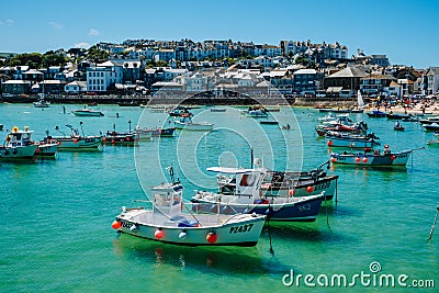 Scenic view of a cornish harbor with fishing boats at high tide in the summer in Cornwall, England Editorial Stock Photo