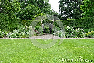 Garden Lawn, Stone Path, Flower Bed and Leafy Trees Stock Photo