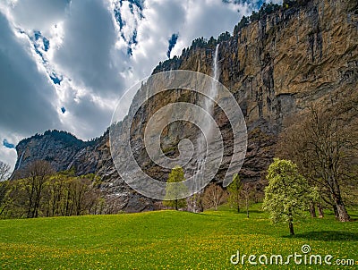 Scenic view of gorgeous Staubbach waterfall in famous Lauterbrunnen valley at spring day, Berner Oberland, Switzerland Stock Photo