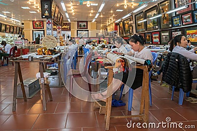 Scenic view of a group of worker doing hand-stitching Vietnam embroidery on the fabric Editorial Stock Photo