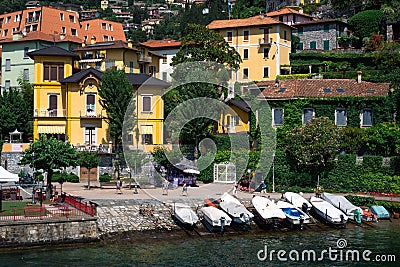 Scenic view of Italian villas and boats moored at the shore on Lake Como in Varenna, Italy. Editorial Stock Photo
