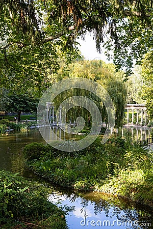 Scenic view of a lush garden overlooking a pond in Paris, France Editorial Stock Photo