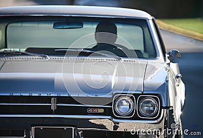 Scenic view of a man driving Oldsmobile 442 on a bright sunny day Editorial Stock Photo