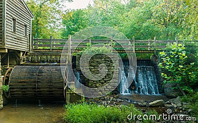 Scenic view of an old wooden watermill in a green forest Stock Photo