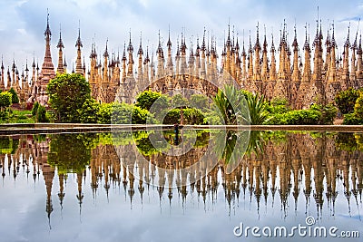 Scenic view of pagodas in Kakku with water reflection, Myanmar Stock Photo