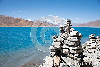 Scenic view of prayer rocks stacked atop one another, overlooking a tranquil lake Stock Photo