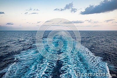 Scenic view of the sea from the stern of a luxurious cruise ship, against the sunrise on a beautiful blue sky Stock Photo