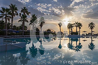 Scenic view of swimming pool by swimming pool against sky during sunset Stock Photo