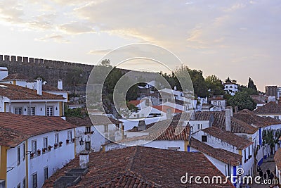Scenic view of white houses red tiled roofs. and castle of Obidos from wall of fortress. Beautiful old town with medieval Stock Photo