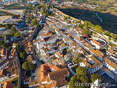 Scenic view of white houses red tiled roofs, and castle from wall of fortress. Obidos village, Portugal. Stock Photo