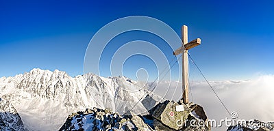 Scenic view of winter mountains peak with cross, High Tatras Stock Photo