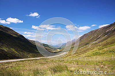 Scenic winding country road along a valley in the Scottish Highlands, United Kingdom Stock Photo