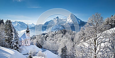 Scenic winter landscape in the Alps with church Stock Photo