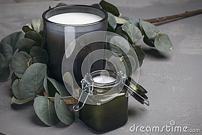 Scented candle in a glass jar on a gray background. Light text background Stock Photo