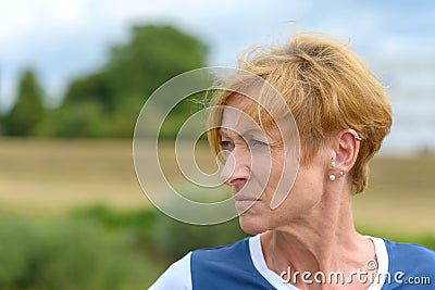 Sceptical woman looking sideways at the camera Stock Photo