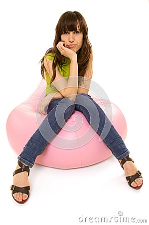 Sceptical woman sitting on chair Stock Photo
