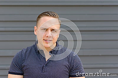 Sceptical young man staring at the camera Stock Photo