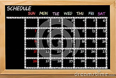 Schedule with grid time table on black chalkboard background Stock Photo