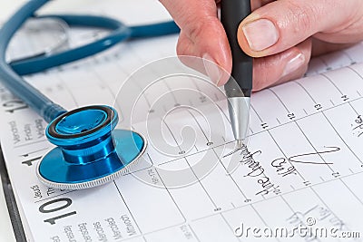 scheduled doctors appointment is wrote on calendar for patient Stock Photo