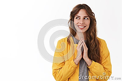 Scheming evil plan. Smart creative young mysterious girl twiddles fingers thinking excellent idea smiling look aside Stock Photo