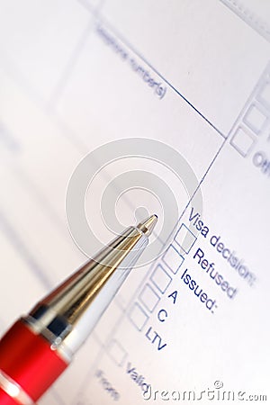 Schengen visa, questionnaire. Hand with pen completing a questionary Stock Photo