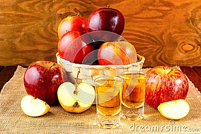 Schnapps drinks and apples in the wicker basket Stock Photo