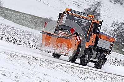 Snow removal winter service with a truck in the Salzkammergut Editorial Stock Photo