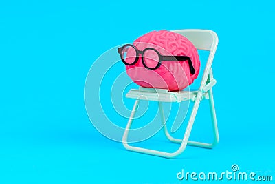 Scholarly Mind: Brain in Glasses on Green Folding Chair Stock Photo