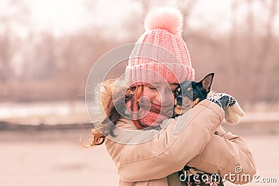 A school-age girl hugs her Chihuahua dog. People and animals. Portrait of teenager girl Stock Photo