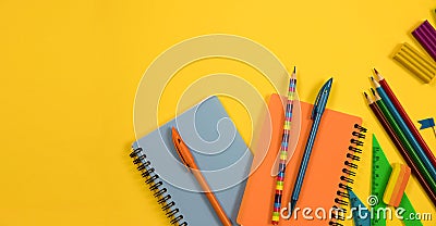 School background. Stationery scattered on a yellow background. Stock Photo