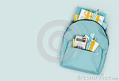 School backpack with different colorful stationery products on blue background Stock Photo