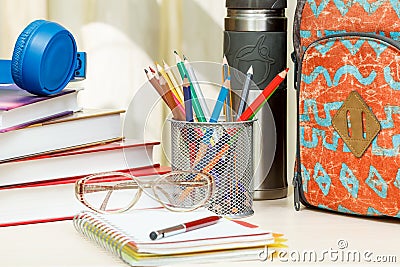 School backpack with school supplies. Books, metal stand for pen Stock Photo