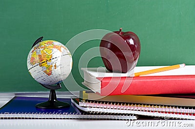 School Books a red Apple and a Globe Stock Photo