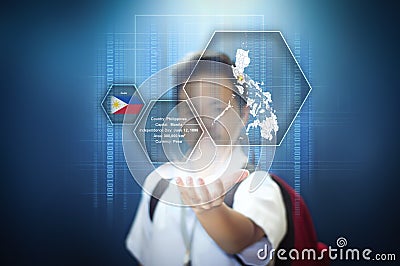 School boy showing facts about the Philippines through virtual screen hologram technology. Stock Photo