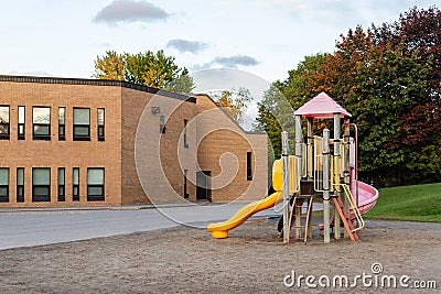 School building and schoolyard with playground without children Editorial Stock Photo