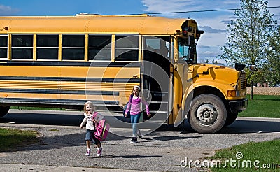 little girls with school bus Stock Photo