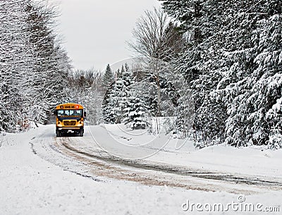 School Bus Driving Down A Snow Covered Rural Road - 1 Stock Photo