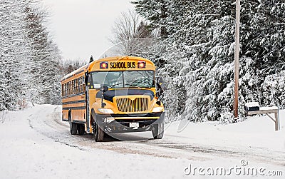 School Bus Driving Down A Snow Covered Rural Road - 3 Stock Photo