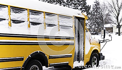 School bus parked in a residential neighborhood during a snow da Stock Photo