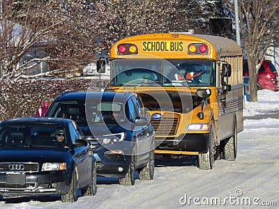 A School bus picking up kids during rush hour in winter Editorial Stock Photo