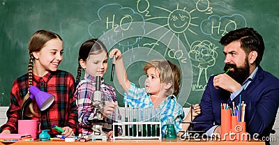 School chemistry experiment. Explaining chemistry to kids. Fascinating chemistry lesson. Man bearded teacher and pupils Stock Photo